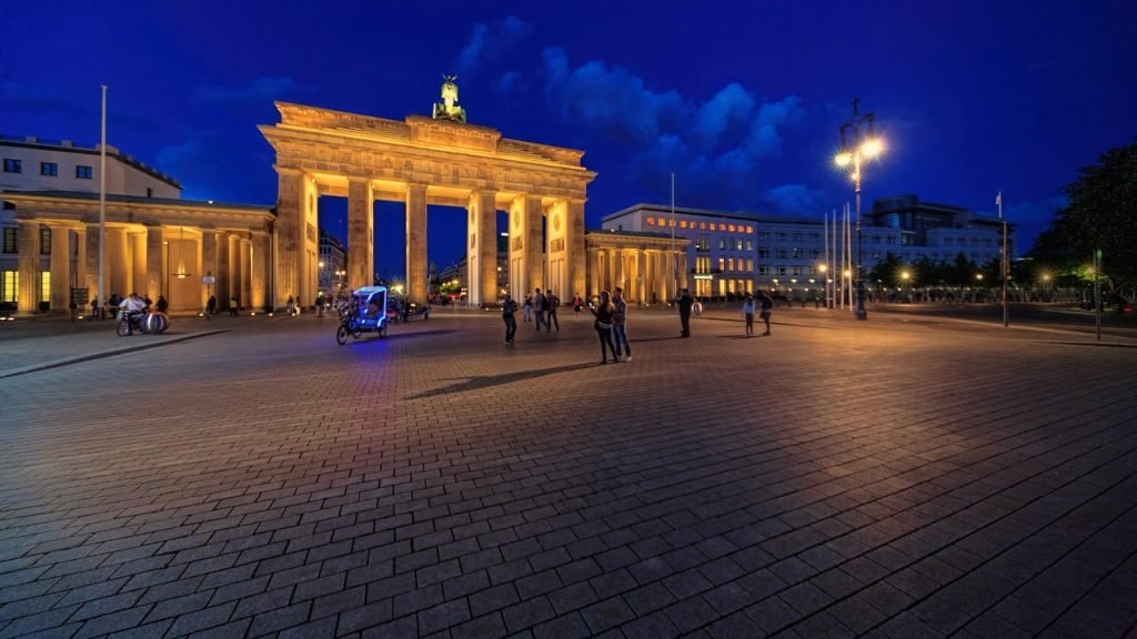 Stunning night view of Berlins Brandenburg Gate lit up, showcasing its grandeur.